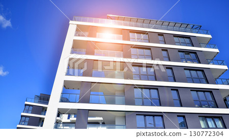 Architectural details of modern apartment building. Modern european residential apartment building complex. 130772304