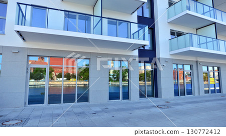 Panoramic windows of new commercial premises. Commercial property in development standard for rent. 130772412