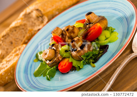 Baked mushrooms with greens and vegetables 130772472