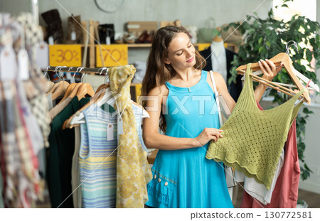 Woman chooses tops for the summer Woman chooses tops for the summer 130772581