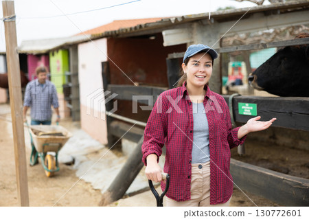 Portrait of smiling young farmer woman in backyard of farm while cleaning Portrait of smiling young farmer woman in backyard of farm while cleaning 130772601