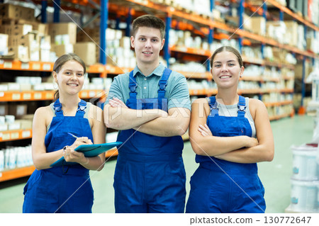 Portrait of three construction supermarket workers in overalls Portrait of three construction supermarket workers in overalls 130772647