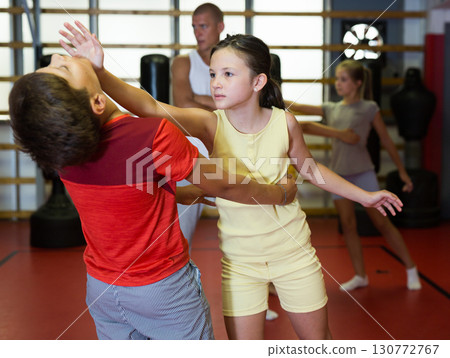 Kids exercising chin strike in gym 130772767