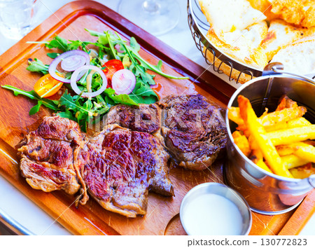 Fried beef served with French fries Fried beef served with French fries 130772823