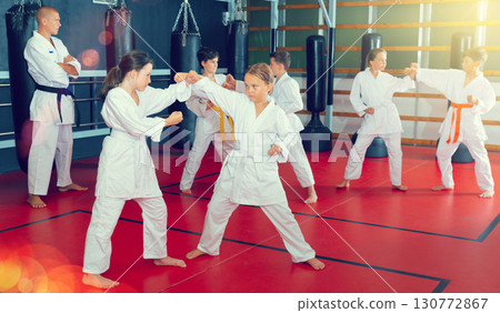 Kids sparring during karate training Kids sparring during karate training 130772867