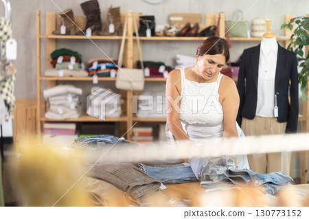 Woman view assortment in clothing department, buying lady denim jeans 130773152