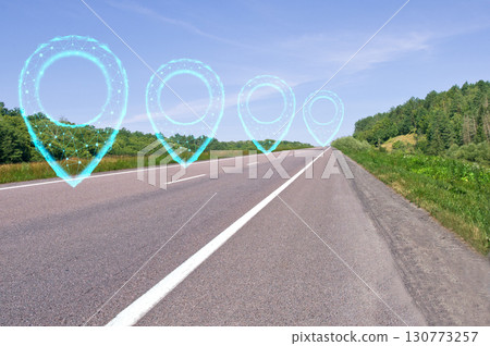Road with polygonal pointers. Highway along green forests and blue sky. Summer natural landscape.  Logistic concept. Navigation concept. 130773257
