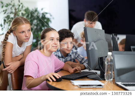 Group of students working at computer in classroom Group of students working at computer in classroom 130773326