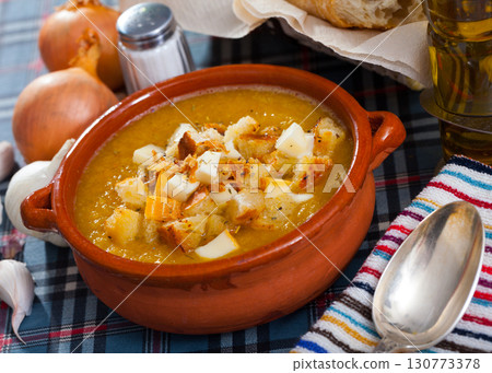 Cream soup of vegetables with toasted bread and cheese Cream soup of vegetables with toasted bread and cheese 130773378