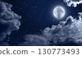Moon and the dark starry sky in the silhouette  of the clouds. 130773493