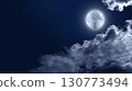 Moon and the dark blue sky in the silhouette  of the clouds. 130773494