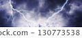 Dramatic lightning strike background in dark cloudy sky 130773538