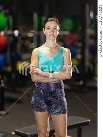 Confident woman standing at gym, ready for training 130773623