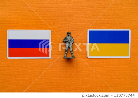 Flags of Russia and Ukraine on a yellow background. The Russian-Ukrainian conflict. 130773744