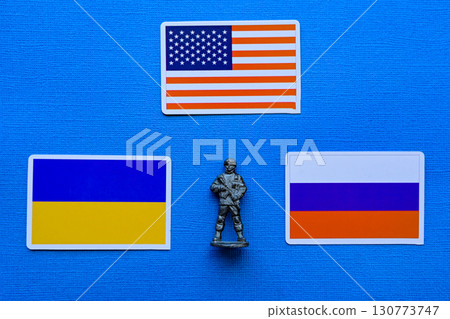 Flags of Russia, Ukraine and the USA on a blue background. The Russian-Ukrainian conflict. Flags of Russia, Ukraine and the USA on a blue background. The Russian-Ukrainian conflict. 130773747
