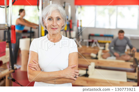 Elderly woman posing in pilates studio 130773921