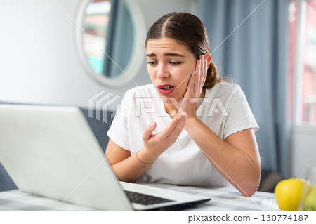 Young woman having video call with doctor Young woman having video call with doctor 130774187