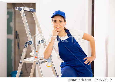 Woman builder standing in apartment 130774206