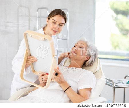 Mature patient with mirror Mature patient with mirror 130774228
