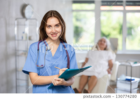 Young doctor with folder 130774280