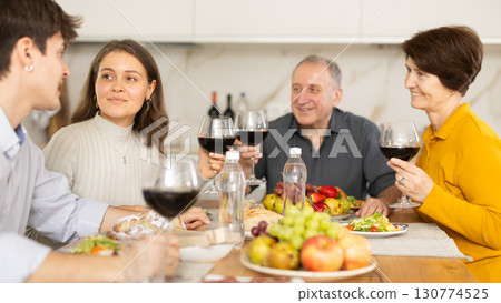 Girl having fun with husband and senior parents at family celebration 130774525