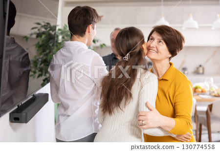 Happy girl introducing boyfriend to parents, coming family celebration Happy girl introducing boyfriend to parents, coming family celebration 130774558