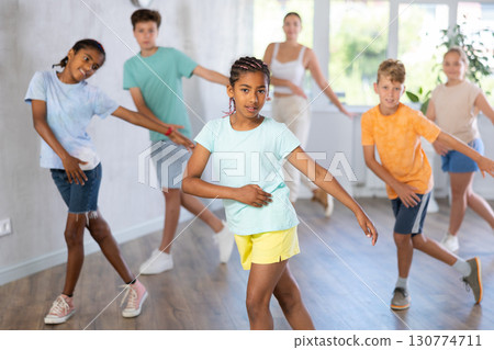 African girl perform social dance vogue with friends and female teacher in background African girl perform social dance vogue with friends and female teacher in background 130774711