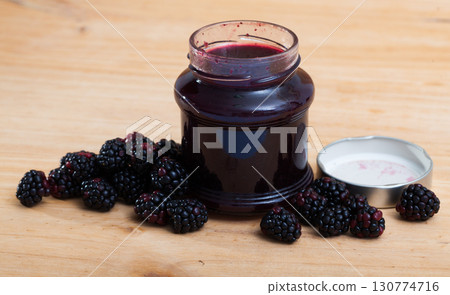 Glass jar of blackberry jam and berries 130774716