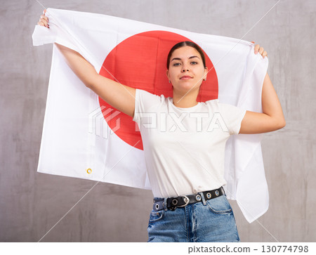 Positive girl with Japan flag rooting for your favorite team 130774798