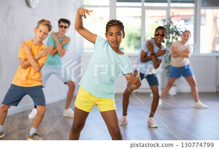 Dark-skinned tween girl krumper posing during workout in dance class 130774799