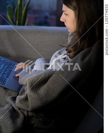 Close up of a young freelancer working remote from home at night Close up of a young freelancer working remote from home at night 130774850