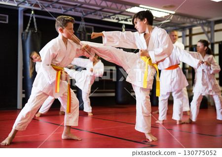 Two boys working in pair, mastering new karate moves 130775052