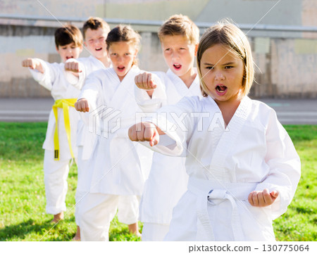 Kids in kimono doing kata moves 130775064