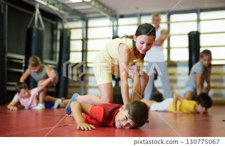 Girl practice self-defense techniques on trainer Girl practice self-defense techniques on trainer 130775067