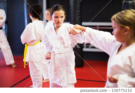 Kids on karate training in gym 130775210