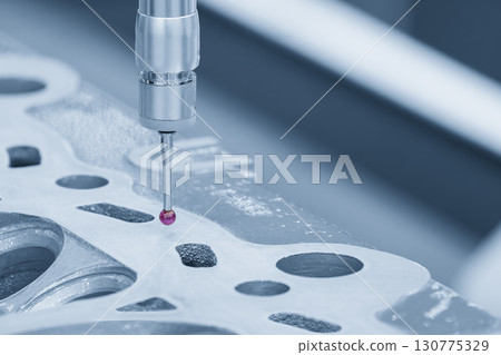 The multi-axis CMM machine measuring the aluminum cylinder head parts. The multi-axis CMM machine measuring the aluminum cylinder head parts. 130775329