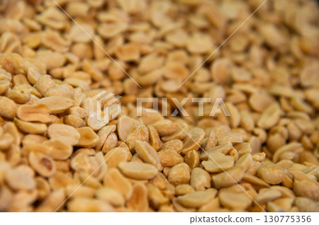 Lots of roasted peanuts as background, top view. Macro shot of peeled peanuts in large volume Lots of roasted peanuts as background, top view. Macro shot of peeled peanuts in large volume 130775356