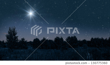 Bright star shines over the manger of christmas of Jesus Christ on blue starry sky Bright star shines over the manger of christmas of Jesus Christ on blue starry sky 130775360