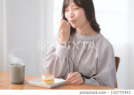 Young woman eating delicious cake Young woman eating delicious cake 130775441