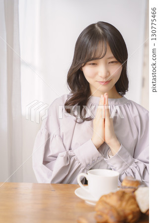 A young woman about to eat after saying "itadakimasu" A young woman about to eat after saying "itadakimasu" 130775466