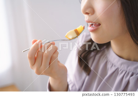 Young woman eating delicious cake Young woman eating delicious cake 130775493
