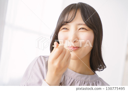 Young woman eating delicious cake Young woman eating delicious cake 130775495