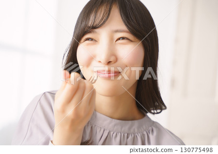 Young woman eating delicious cake Young woman eating delicious cake 130775498