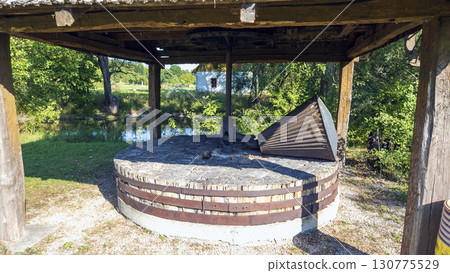 Antique shredder, branch crusher under a wooden roof in Slovakia. Close-up. 130775529