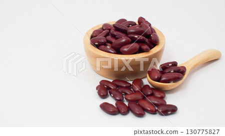 Kidney beans in a wooden bowl and spoon with scattered beans on a clean white background, representing healthy food, natural ingredients Kidney beans in a wooden bowl and spoon with scattered beans on a clean white background, representing healthy food, natural ingredients 130775827