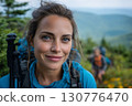 Beautiful and Strong Women: A Portrait Of A Confident Female Hiker Smiling On A Mountain Trail With A Scenic View. 130776470