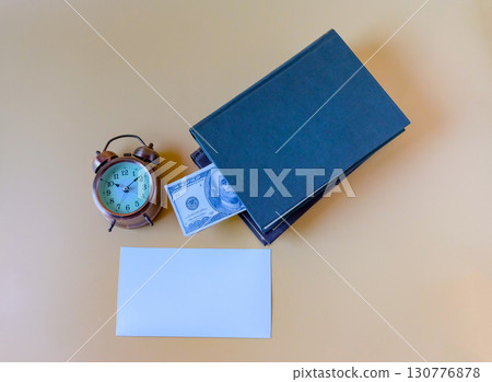 A pile of books with US banknotes,saving hidden. A pile of books with US banknotes,saving hidden. 130776878