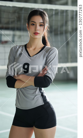 Korean volleyball player in sports attire standing confidently on the court during a practice session Korean volleyball player in sports attire standing confidently on the court during a practice session 130777263