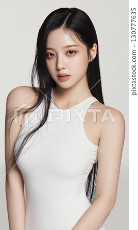 Captivating portrait of a young Asian woman with long black hair posing elegantly in a simple white outfit Captivating portrait of a young Asian woman with long black hair posing elegantly in a simple white outfit 130777635
