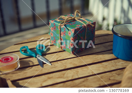 Gift Wrapping Scene with Scissors and Floral Present Gift Wrapping Scene with Scissors and Floral Present 130778169